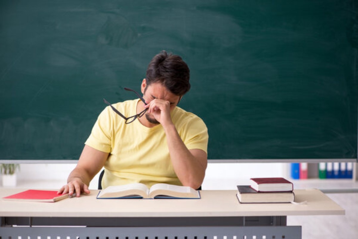 Teacher burnout. Teacher stress. Student men. University students photo.