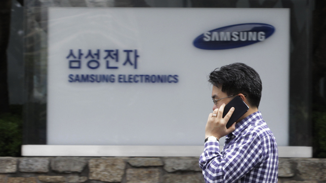 Aug. 24, 2012: A man walks by Samsung Electronics Co.'s headquarters in Seoul, South Korea. The Seoul Central District Court ruled Friday that technology rivals Apple Inc. and Samsung Electronics Co. both infringed on each other's patents.