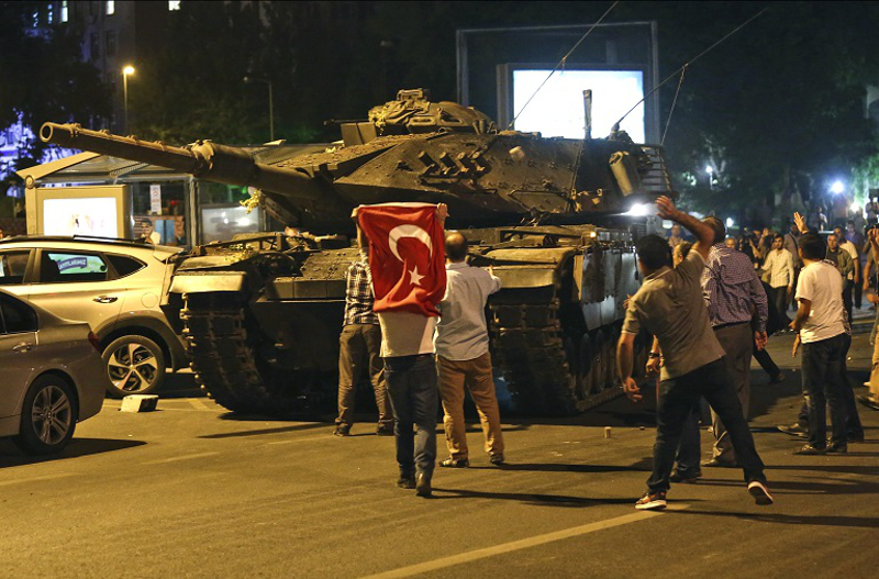 Tanks move into position as Turkish people attempt to stop them, in Ankara, Turkey, early Saturday, July 16, 2016. Turkey's armed forces said it "fully seized control" of the country Friday and its president responded by calling on Turks to take to the streets in a show of support for the government. A loud explosion was heard in the capital, Ankara, fighter jets buzzed overhead, gunfire erupted outside military headquarters and vehicles blocked two major bridges in Istanbul. (AP Photo)