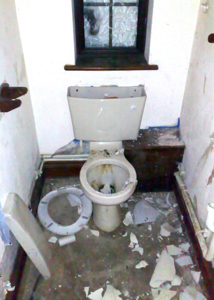 The downstairs toilet in the abandoned and derelict mansion of £9.4m lottery lout Michael Carroll. The house set in vast grounds is in a terrible state with every window smashed and every room trashed with litter left in great piles.