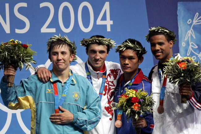 Medalists celebrate on the podium during an awarding ceremony of the middleweight boxing in the 2004 Athens Summer Olympic Games at the Peristeri boxing hall in Athens Saturday, Aug. 28, 2004. From left, silver medalist Kazakstan's Gennadiy Golovkin, gold medalist Russia's Gaydarbek Gaydarbekov, bronze medalists Thailand's Prasathinphimai Suriya and American Andre Dirrell, from Flint, Mich. (AP Photo/Rick Bowmer)