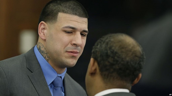 Former New England Patriots tight end Aaron Hernandez cies as he turns to defense attorney Ronald Sullivan reacting to his double murder acquittal after the sixth day of jury deliberations at Suffolk Superior Court Friday, April 14, 2017 in Boston. Hernandez stood trial for the July 2012 killings of Daniel de Abreu and Safiro Furtado who he encountered in a Boston nightclub. The former NFL player is already serving a life sentence in the 2013 killing of semi-professional football player Odin Lloyd. (AP Photo/Stephan Savoia, Pool)
