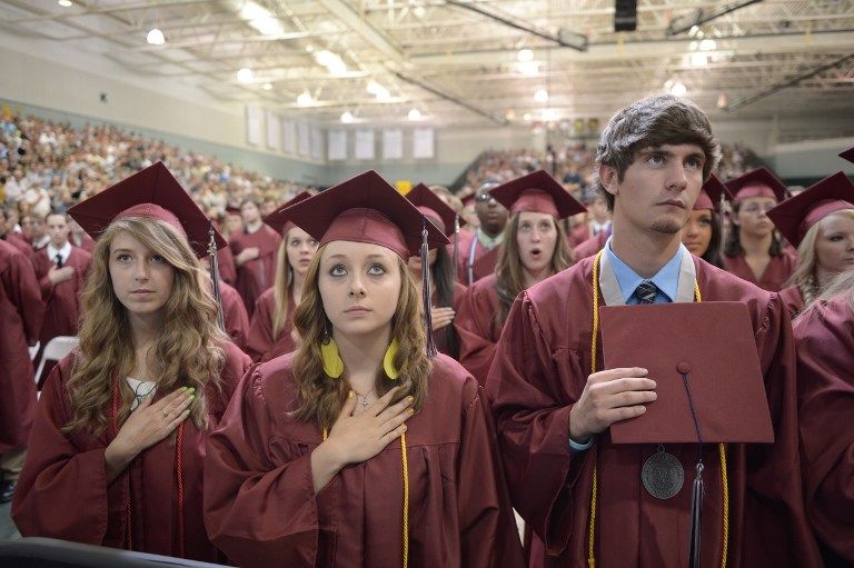 Students listen to then national anthem prior to US President Barack Obama's delivering of the commencement address on May 21, 2012 at Missouri Southern State University in Joplin, Missouri. AFP PHOTO/Mandel NGAN